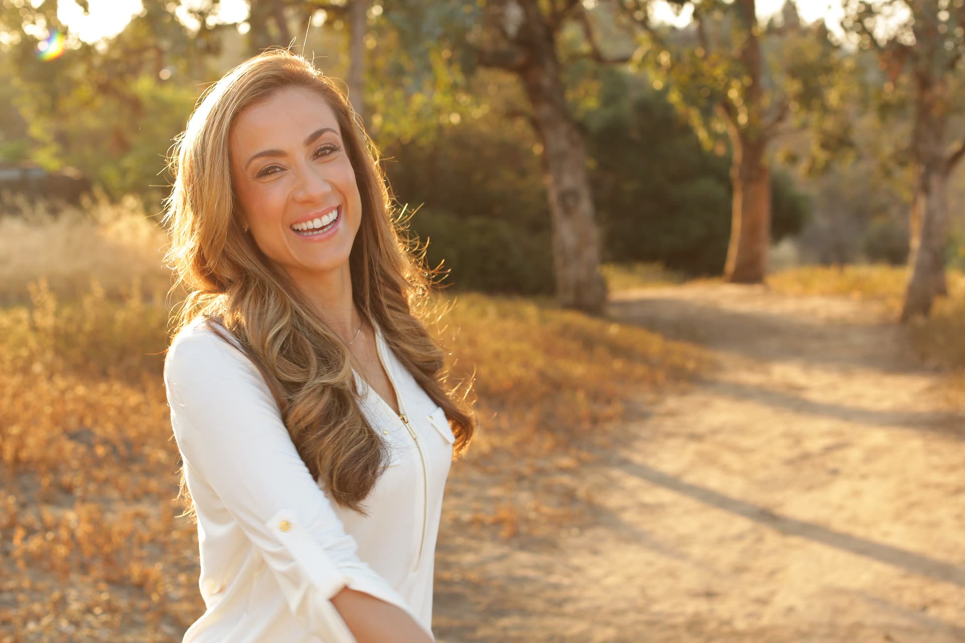 Shelley Davidescu, LMFT, smiling on a sunlit trail