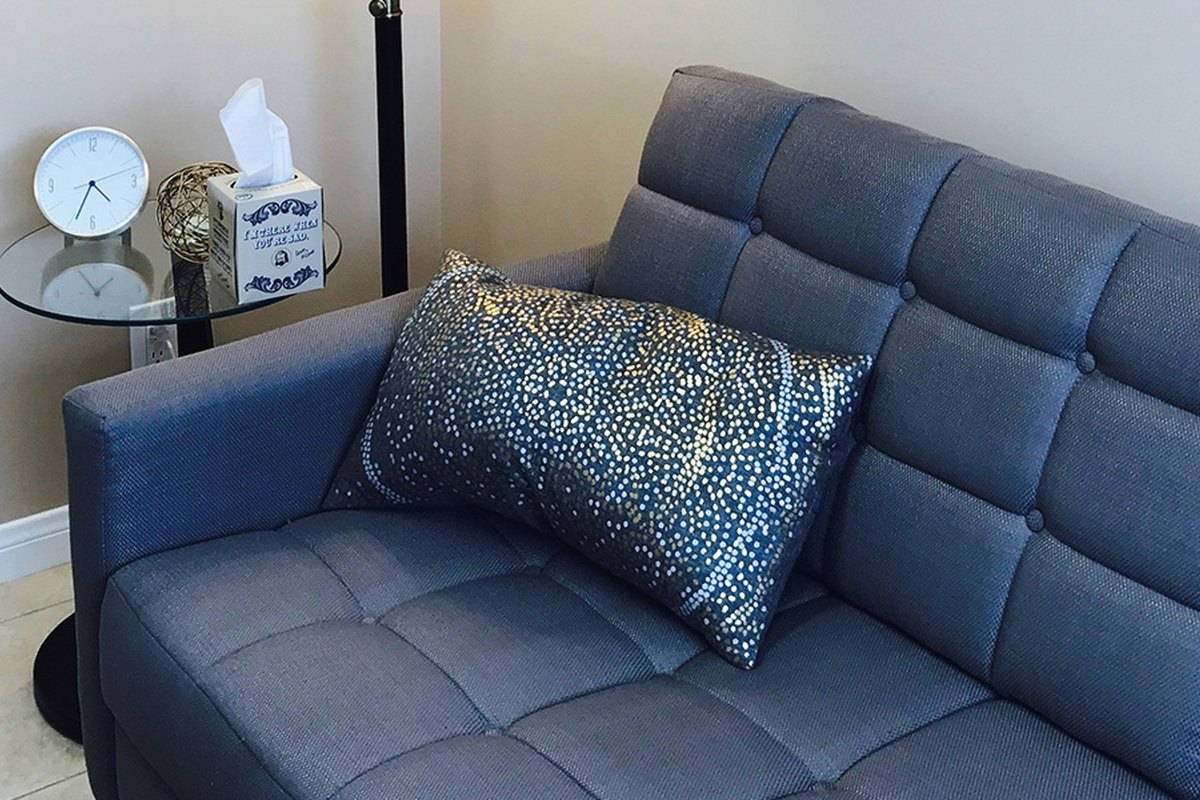 The therapy office in San Diego with a navy sofa and soft daylight